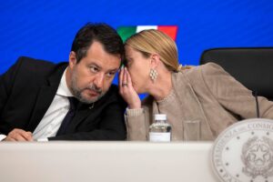 il premier giorgia meloni che parla all'orecchio del ministro dei trasporti matteo salvini