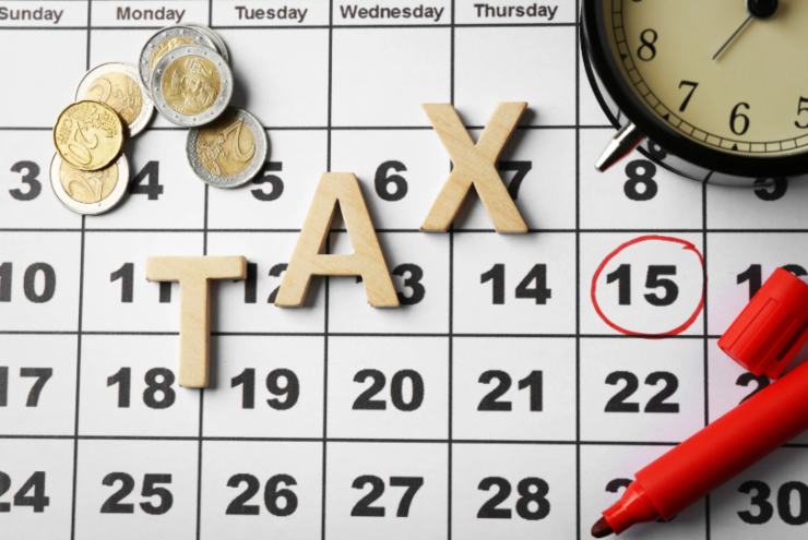 calendario, sveglia, monete di euro e la scritta "tasse"